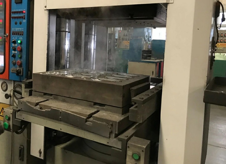 Automated hot press molding machine manufacturing brake pads for 2005 Chrysler Town and Country in factory production line