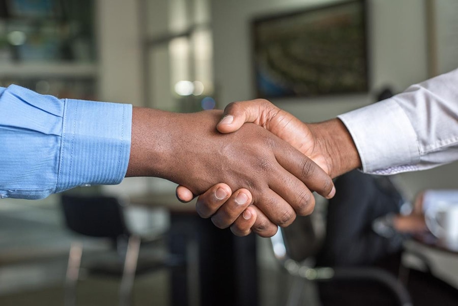 international business handshake automotive parts supplier partnership agreement